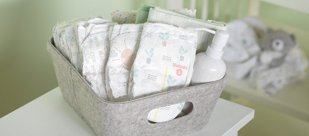 An assortment of Huggies Special Delivery Diaper designs in a gray tote