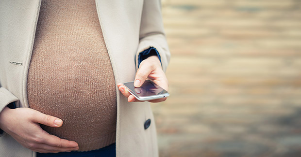 Pregnant belly with a cell phone
