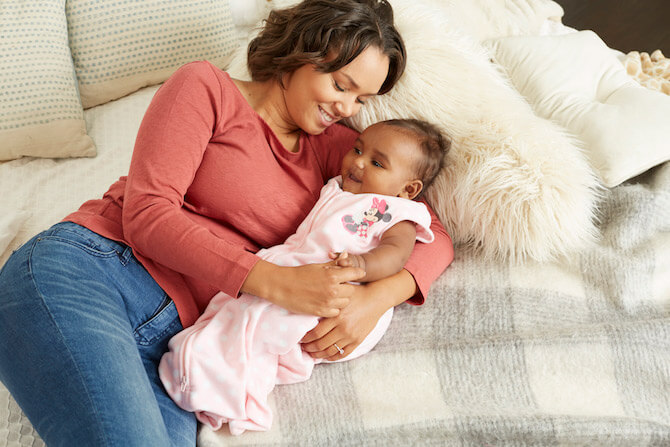 Mom with baby in blanket on couch