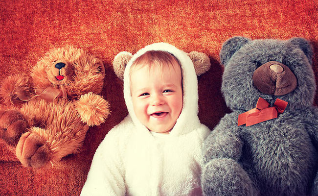 toddler in costume with stuffed bears